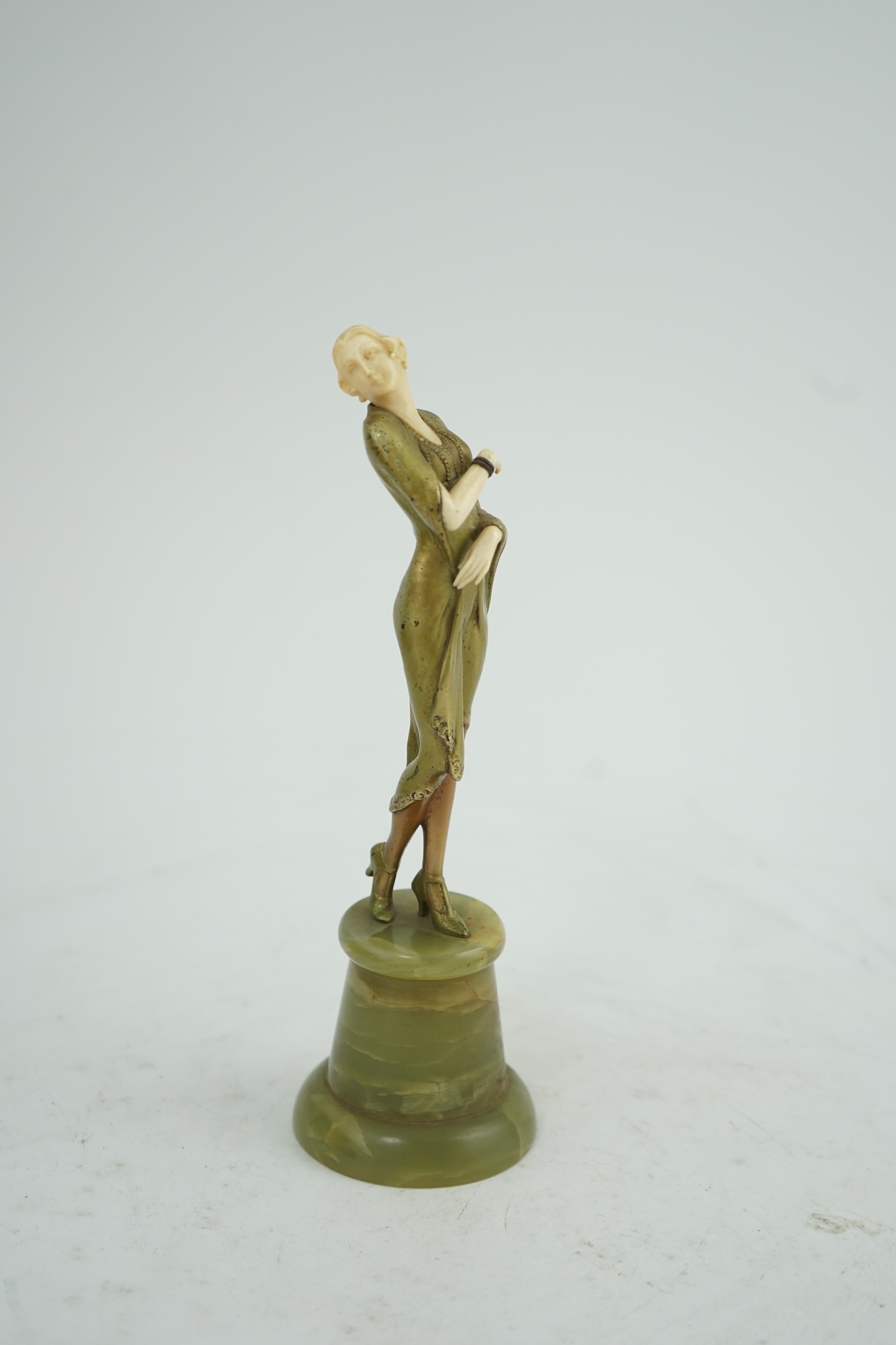 Attributed to Josef Lorenzl. An Art Deco bronze and ivory figure of a stylish lady